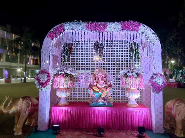 Entrance: Hanging flower strings; pink lighting; idols or deity focal point