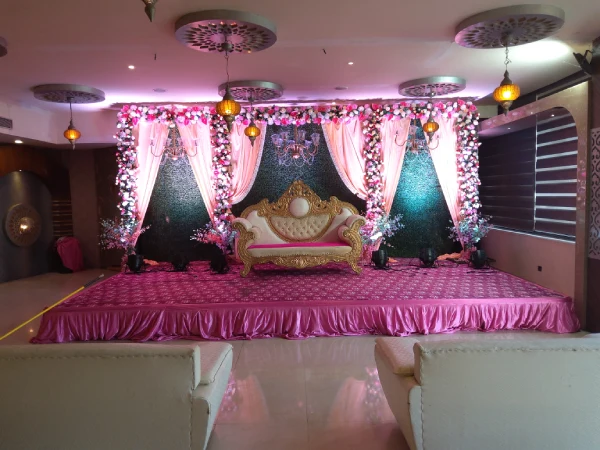 Reception: Center seating; hanging florals; warm pink lighting